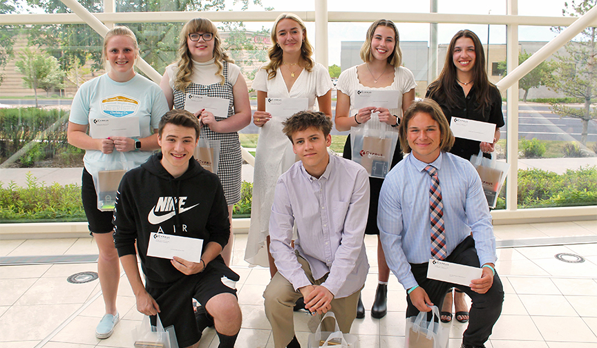 Eight Utah students pose together with their $1,000 checks from Cyprus Credit Union