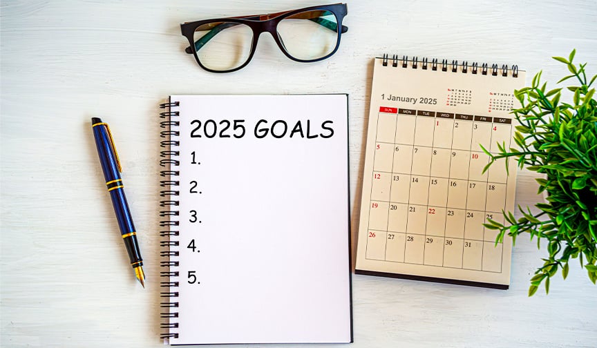 notebook, glasses, pen, and calendar on a table