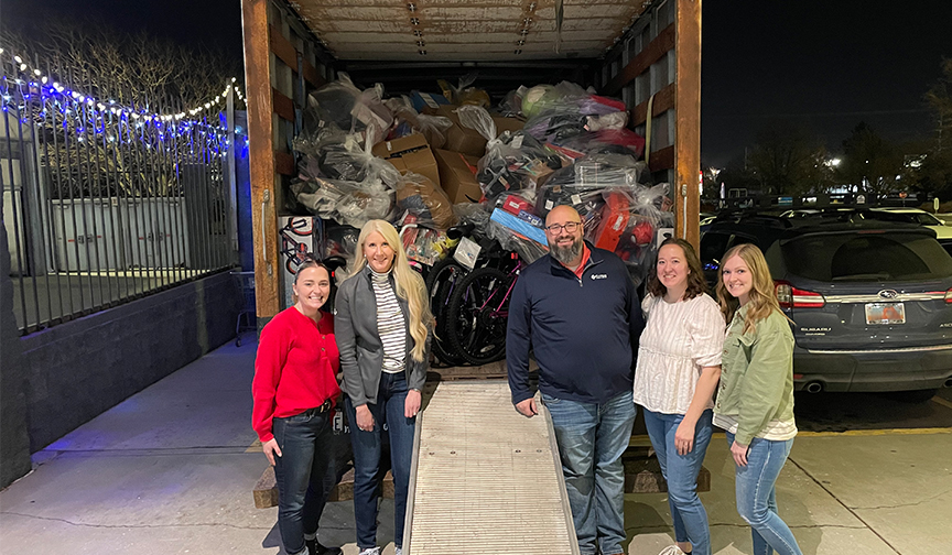 Cyprus Credit Union employees pose in front of a truckload of gifts for the Salvation Army's 2023 Angel Tree program