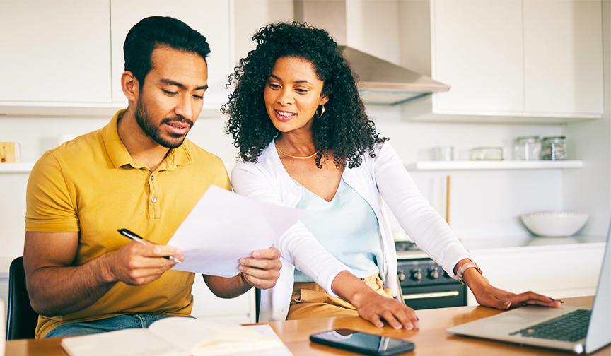 couple working on documents sitting on desk