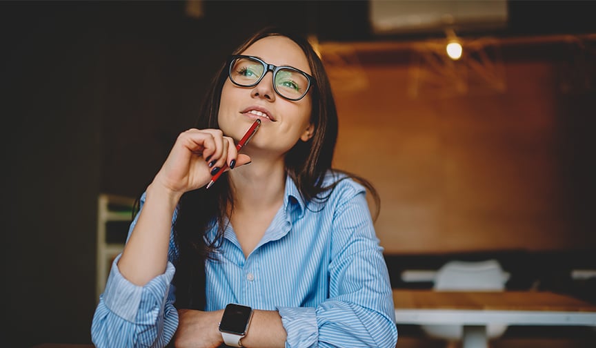 Thoughtful woman pauses from reading