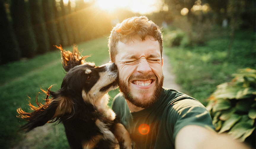 Dog licking man's face