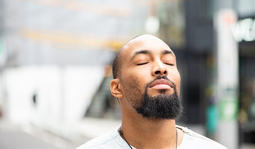 Man takes a moment to breath and be mindful